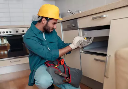 A Handyman for Dade City FL installing a new shelf and cabinet in a kitchen
